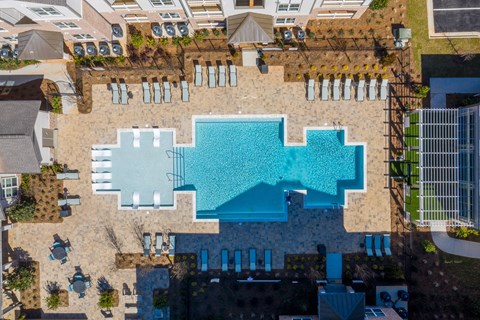 Resort-style swimming pool with furnished sun deck at Argento at Riverwatch in West Augusta, GA