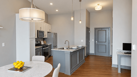 A modern kitchen with a dining table and chairs.
