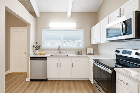 A kitchen with white cabinets and black appliances.