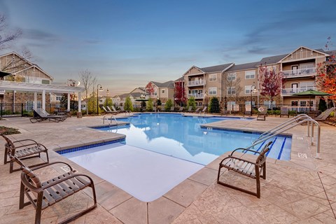 Resort-style swimming pool with sundeck at Wellsley Park Apartments in Knoxville, TN
