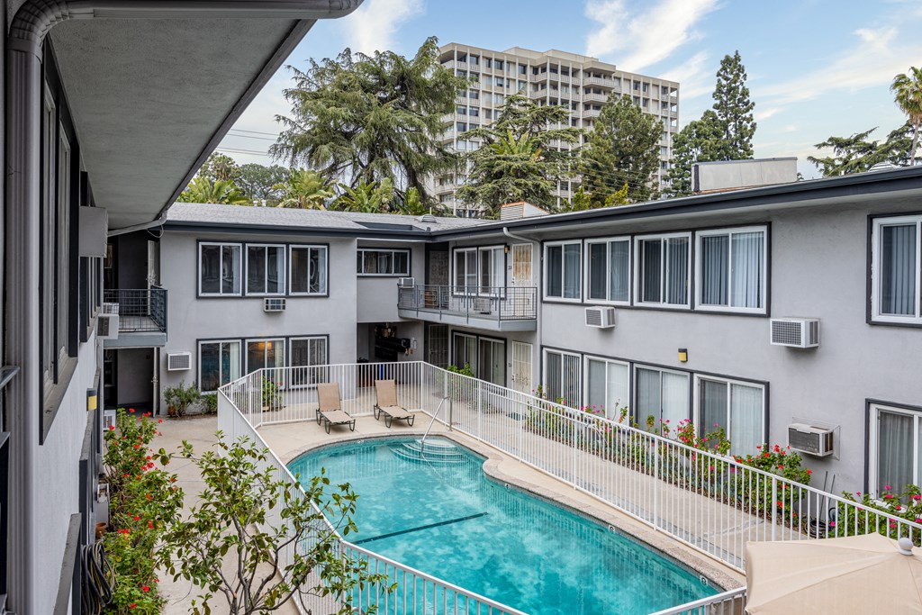 a view of the pool and pool house from the balcony