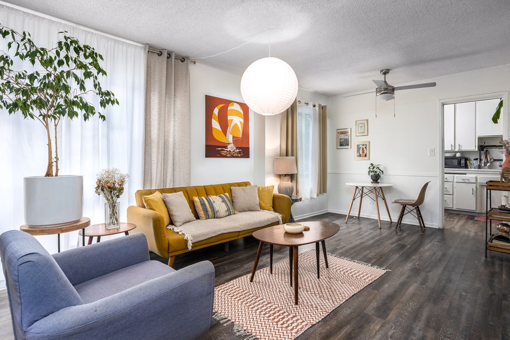 a living room with a yellow couch and a table