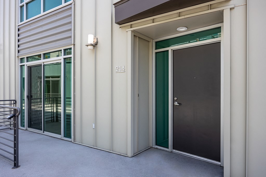 the entrance to a building with two doors and a staircase