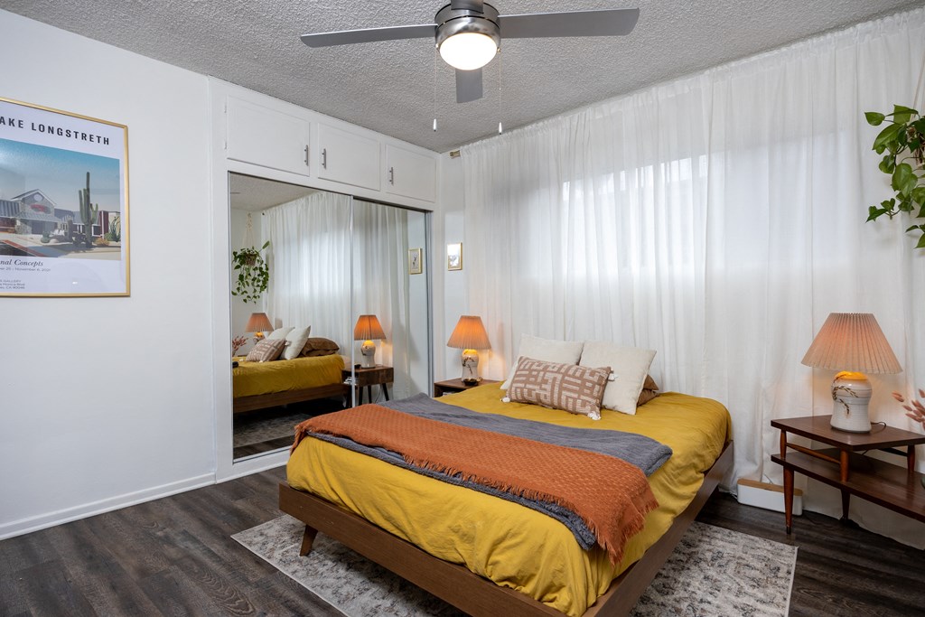 a bedroom with a bed and a ceiling fan