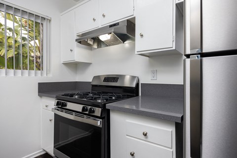 the preserve at ballantyne commons apartment kitchen with stove and refrigerator