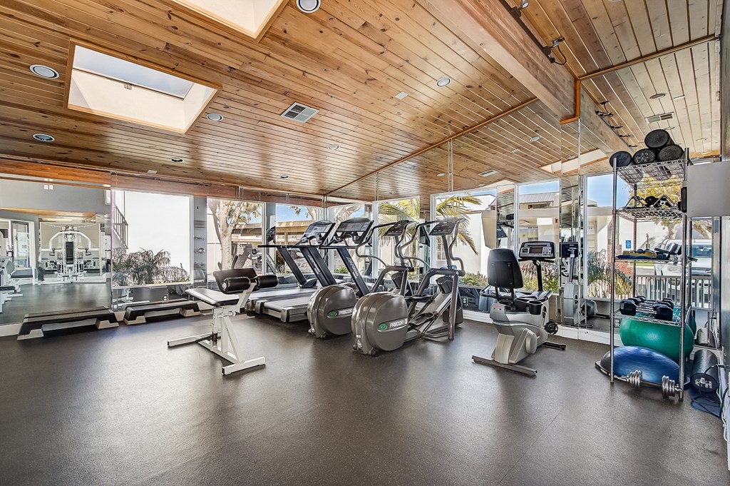 a gym with treadmills and other exercise equipment