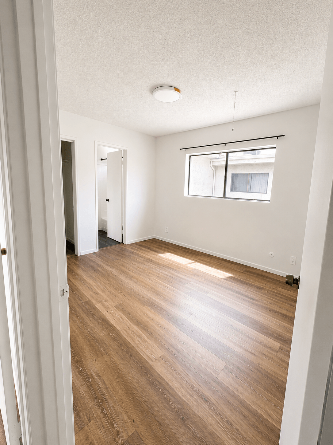 A room with wooden floors and white walls.