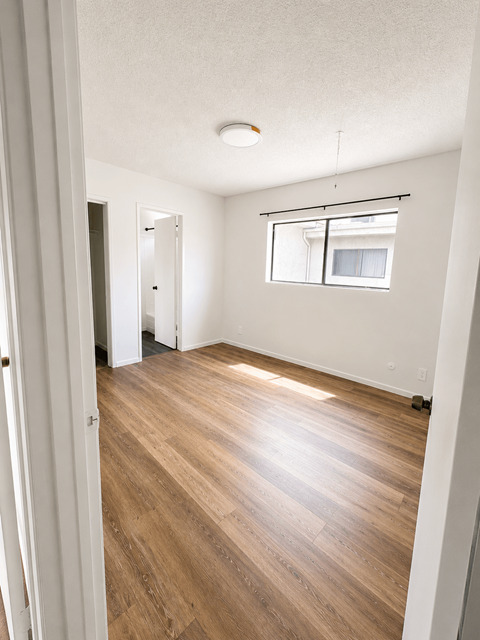 A room with wooden floors and white walls.