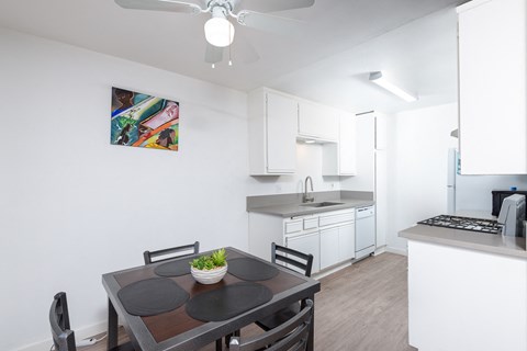 a kitchen and dining room with a table and chairs