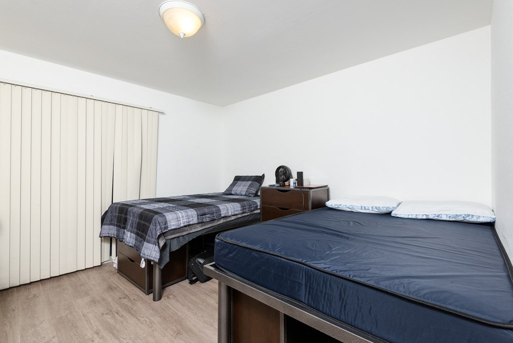 Furnished bedroom with bunk beds and desks