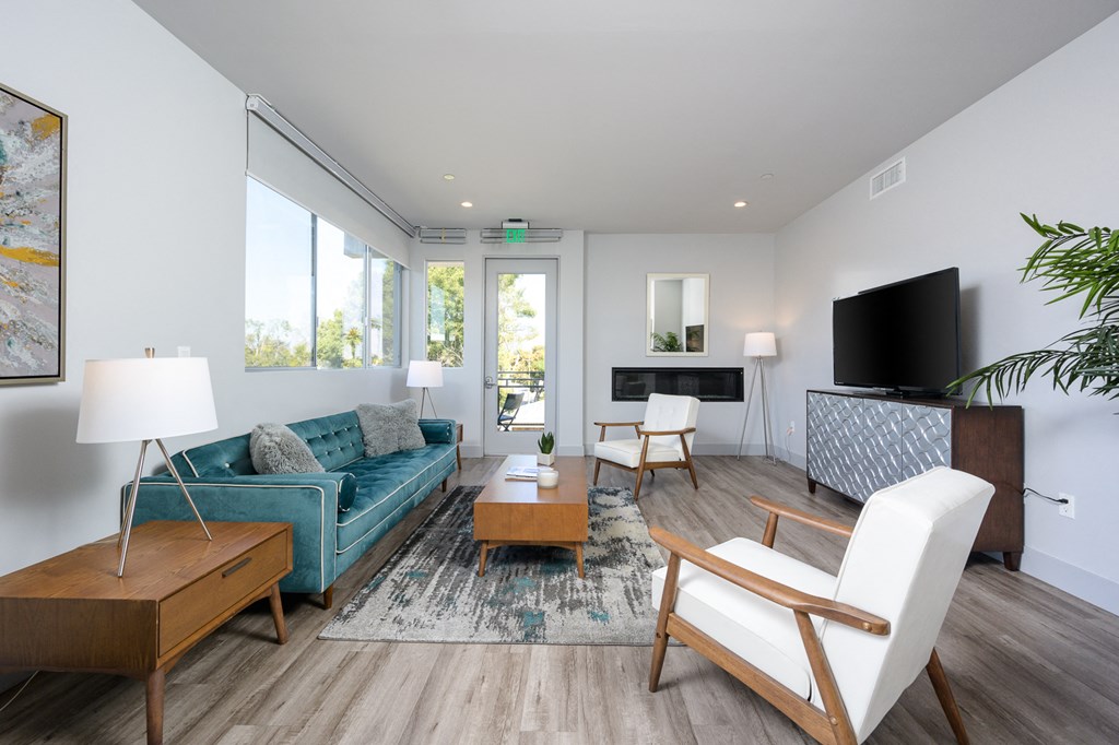 a living room with a blue couch and a tv