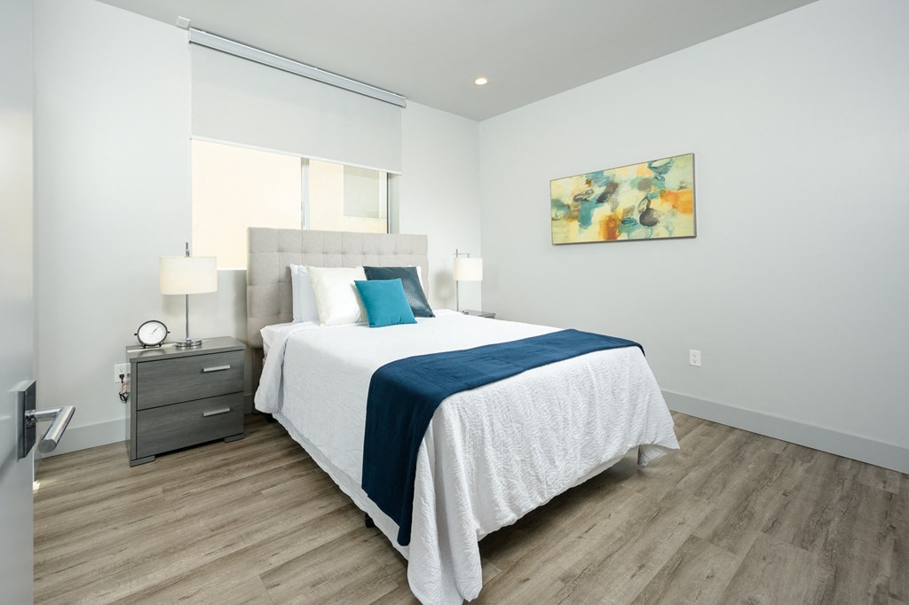 a bedroom with a bed and a window