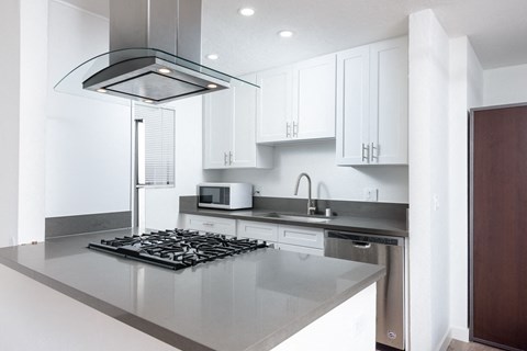 a kitchen with white cabinets and a stove and a microwave