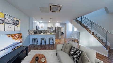 A modern living room with a staircase leading to the upper level.
