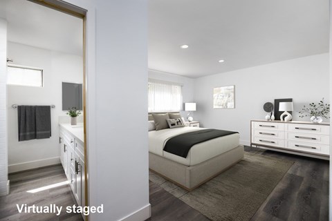 A bedroom with a bed, nightstand, and dresser.