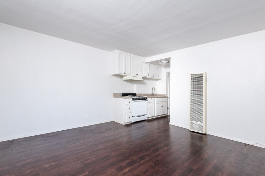 a kitchen with white walls and wood floors - Photo Gallery