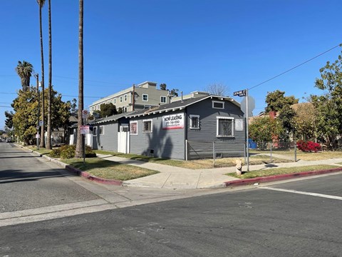 A street view of a house with a "For Rent" sign.