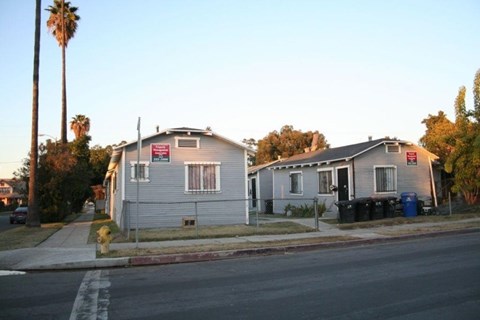 A house with a grey roof and a red sign on it.