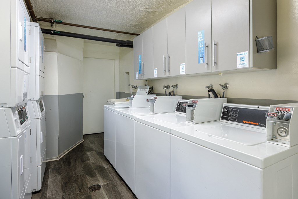 a laundry room with washers and dryers