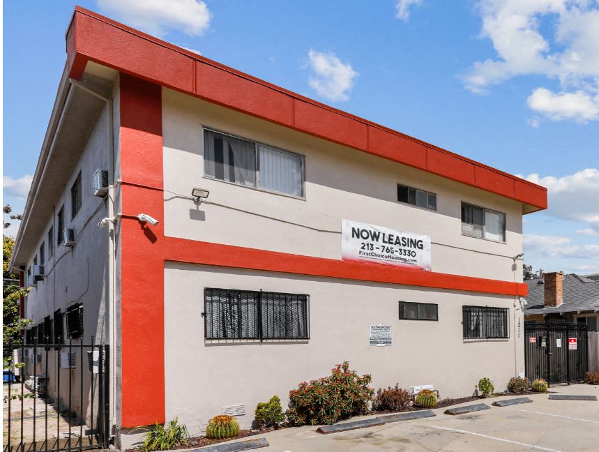 a red and white building with a sign on it