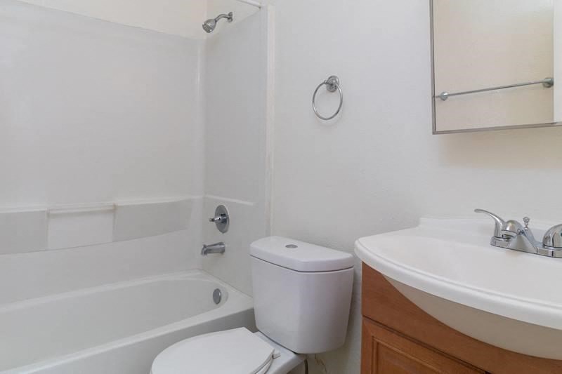 an empty bathroom with a sink toilet and bath tub