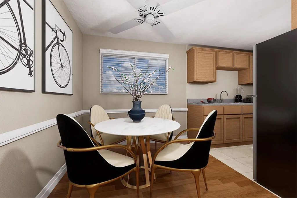 A dining room with a table and chairs.