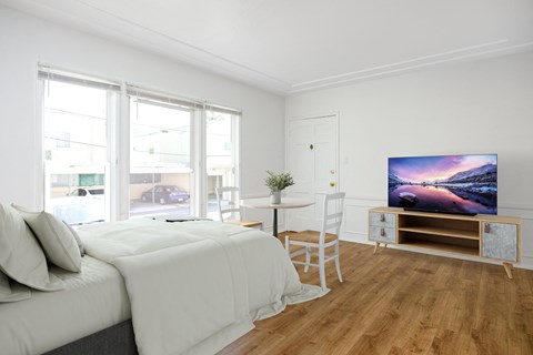a bedroom with a bed and a tv on a table