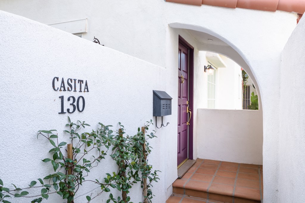 the entrance to the casita 1300 building with a purple door