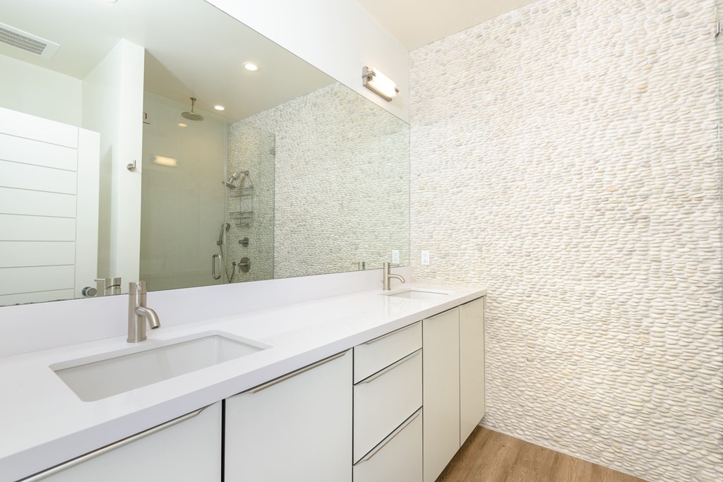 a large white bathroom with a sink and a mirror