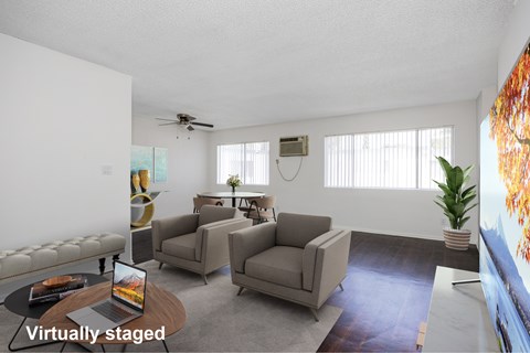 A living room with a couch, chairs, and a coffee table.