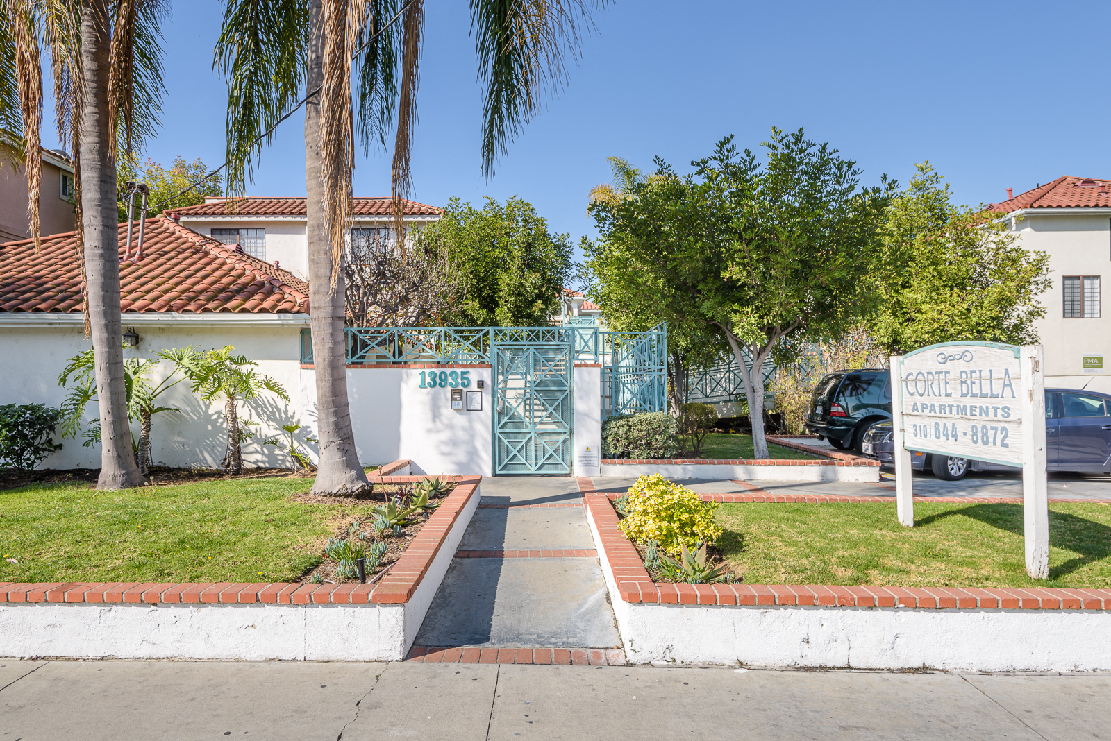 a house with a sign on the side of a street