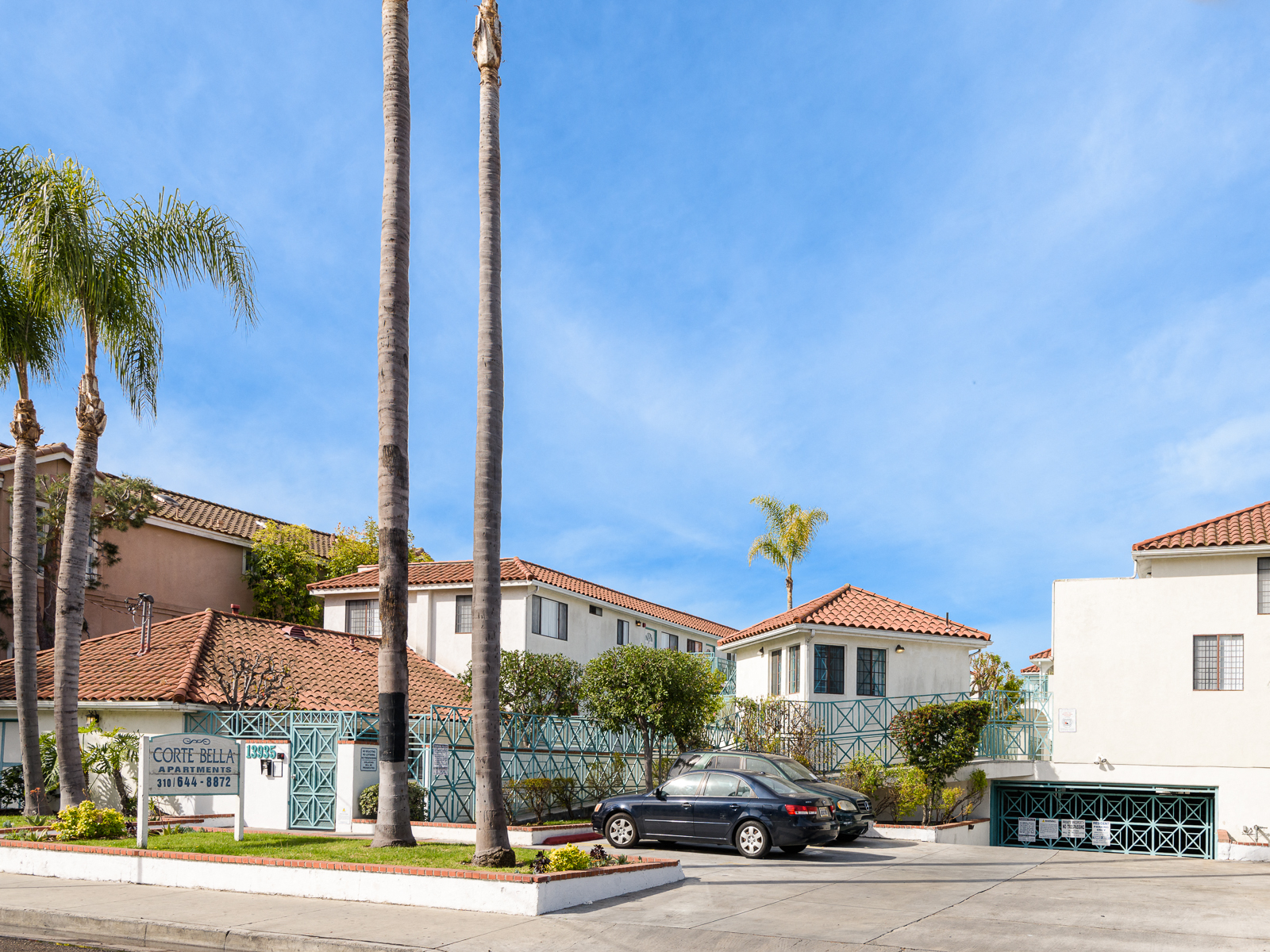 a row of houses with cars parked in front of them