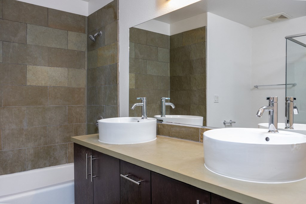 a bathroom with two sinks and a large mirror