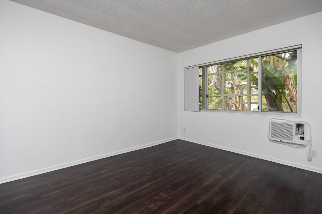 an empty room with white walls and a window