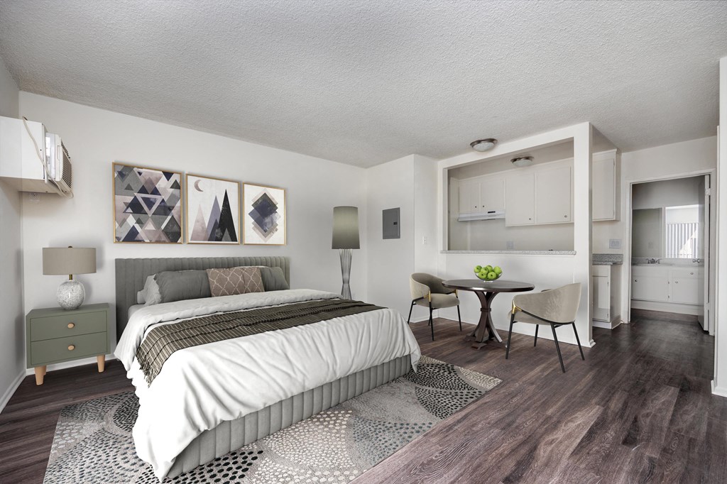 a bedroom with a bed and a table and chairs