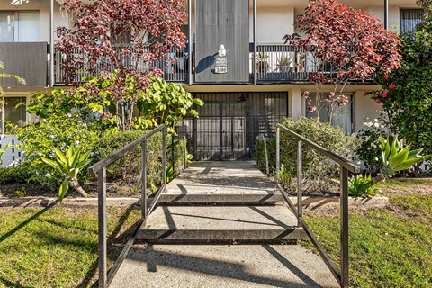 A metal gate blocks the entrance to a courtyard.