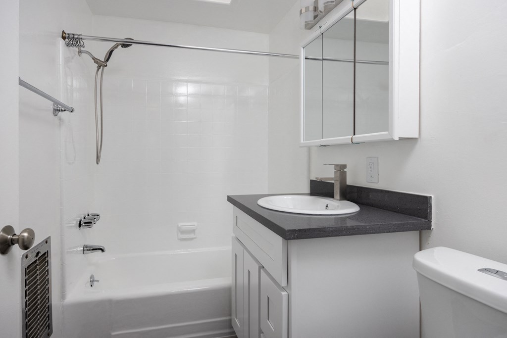 an empty bathroom with a sink and a shower
