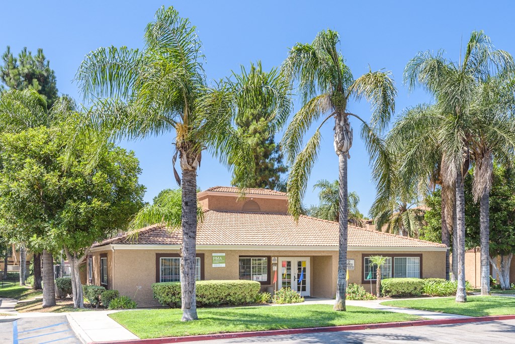 a house with palm trees in front of it