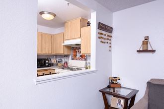 a kitchen with wood cabinets and a window