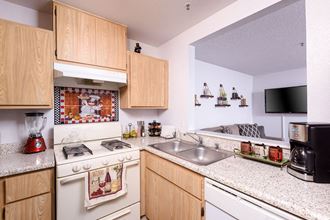 a kitchen with a stove top oven next to a sink