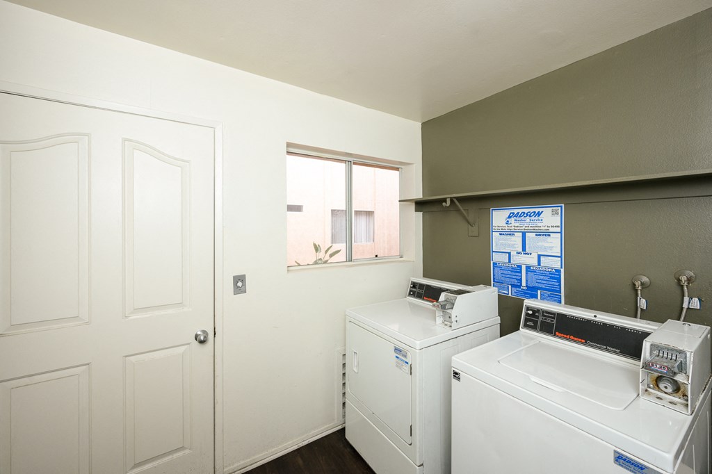 a laundry room with a washer and dryer and a window