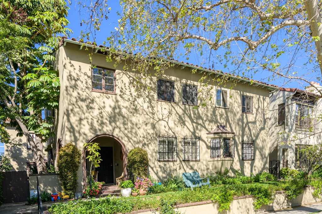 a white house with a tree in front of it
