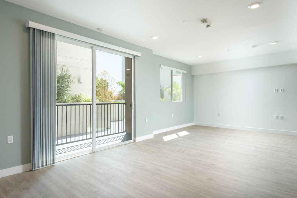 a living room with a large window and a balcony