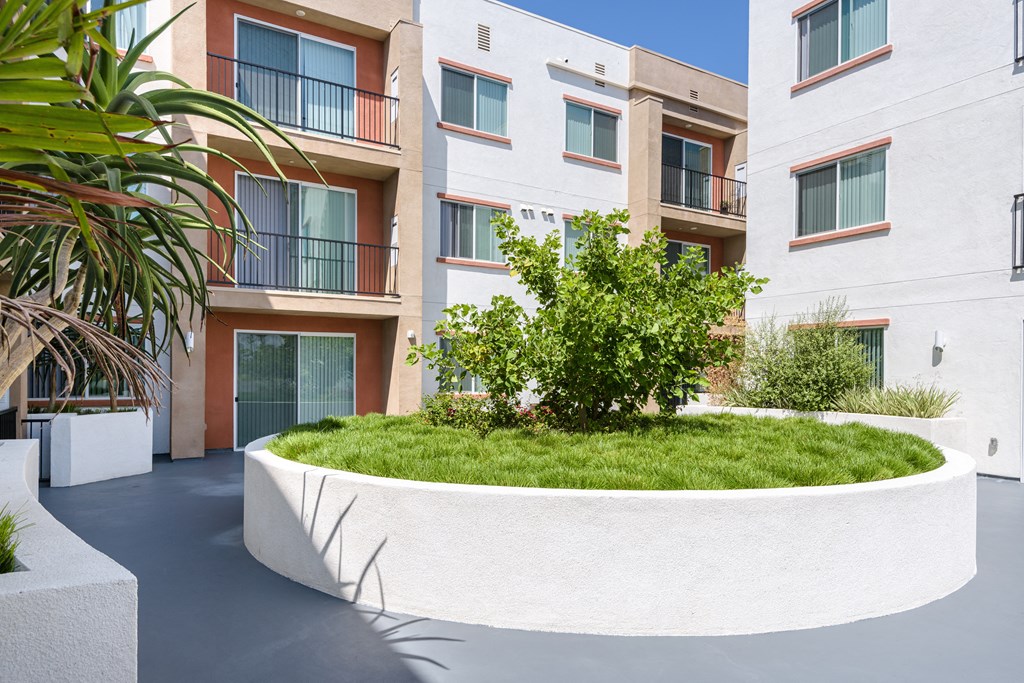 a large white planter in front of an apartment building