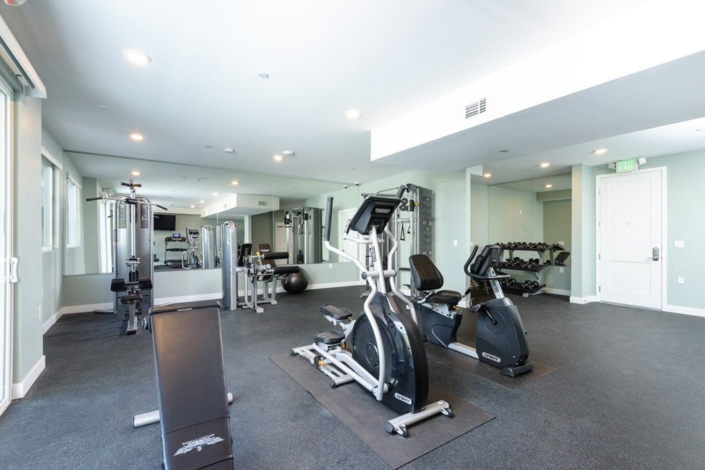 a gym with treadmills and other exercise equipment in a building