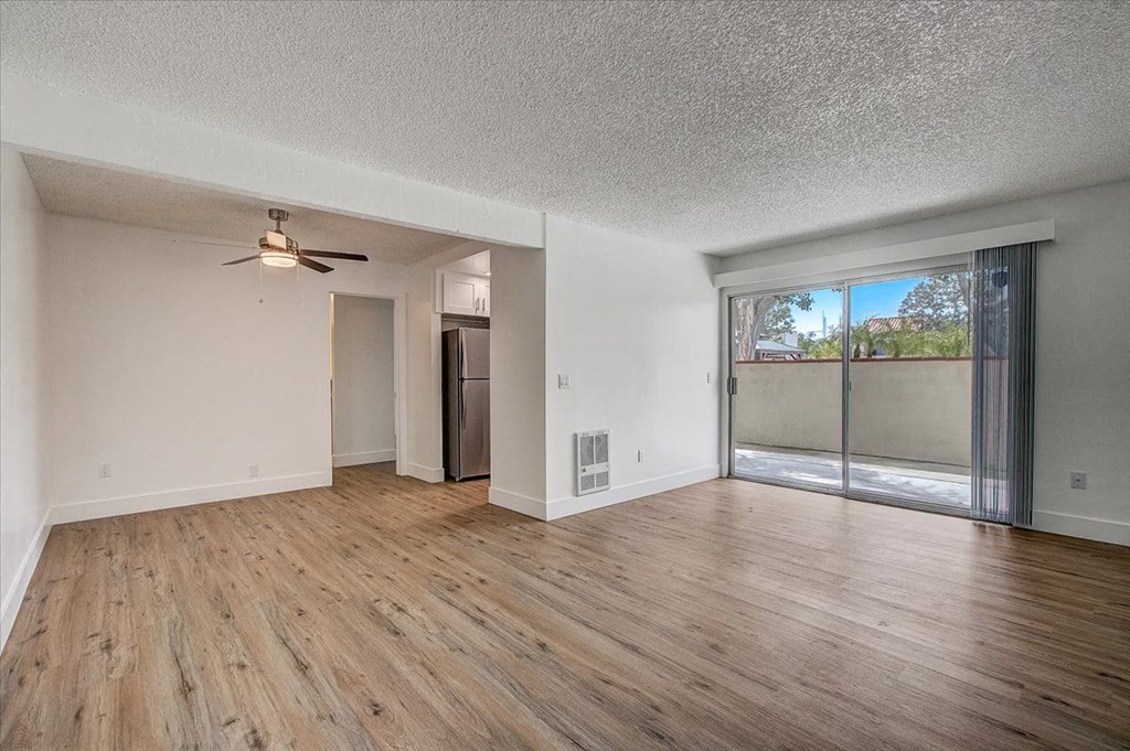 an empty living room with a sliding glass door