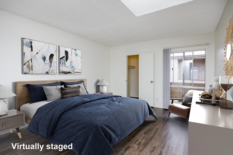 A bedroom with a bed, nightstand, and a painting on the wall.