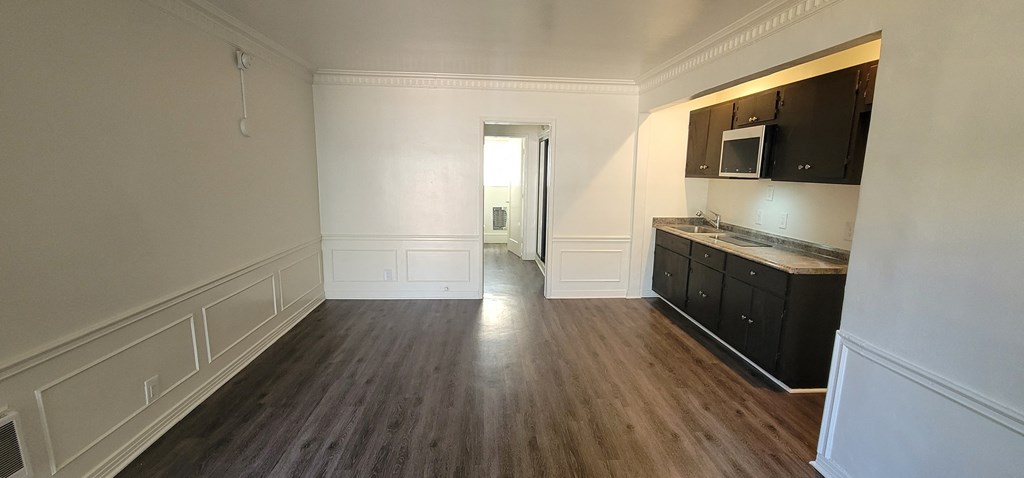 a kitchen and living room of an empty apartment