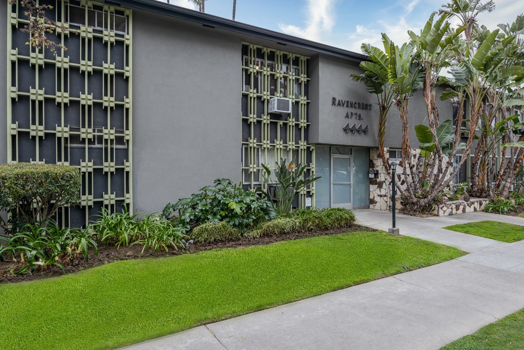 a building with a lawn and trees in front of it