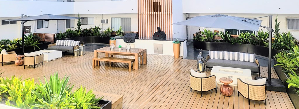 A wooden deck with furniture and plants.